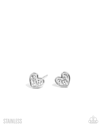 Heart-shaped silver earrings with clear gemstones on a white background