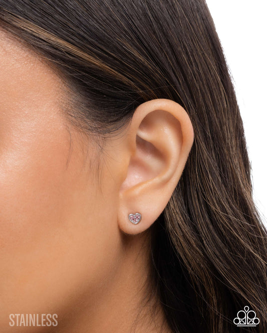 Close-up of an ear wearing a stud earring with a white background