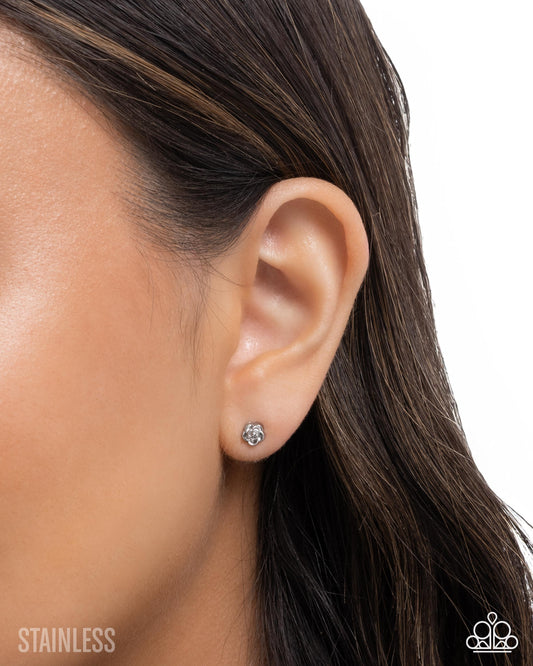Earring worn on an ear with a white background