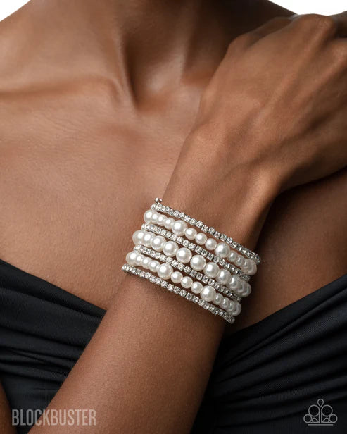 Pearl bracelet on a wrist with a blurred background