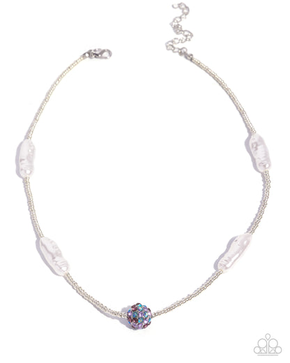 Necklace with a central multicolored bead and white beads on a white background