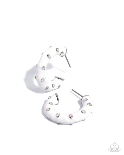 White hoop earrings with small embellishments on a white background