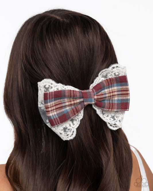 Plaid bow hair clip with lace details on a person's head against a white background