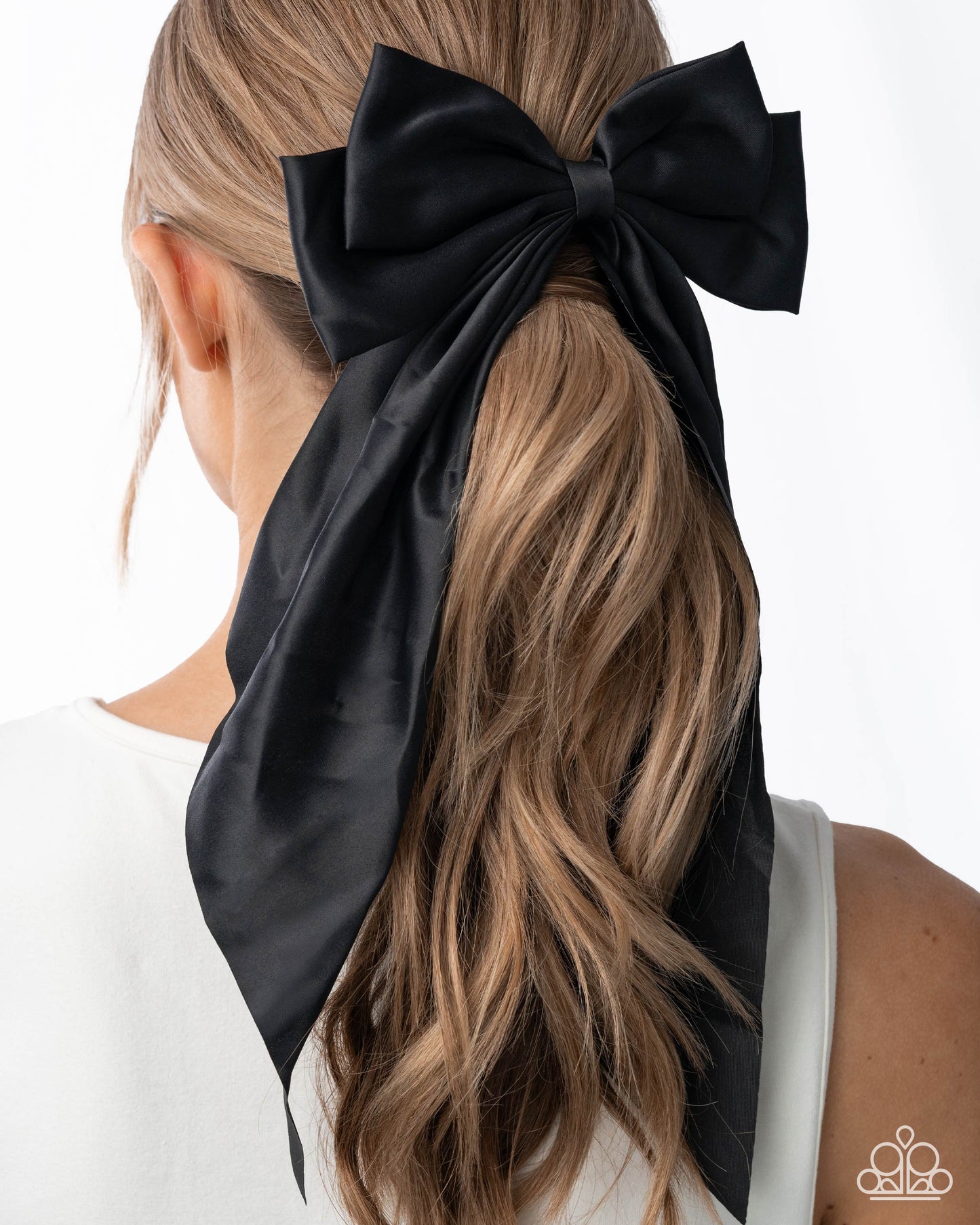Black hair bow tied in a ponytail with a white background
