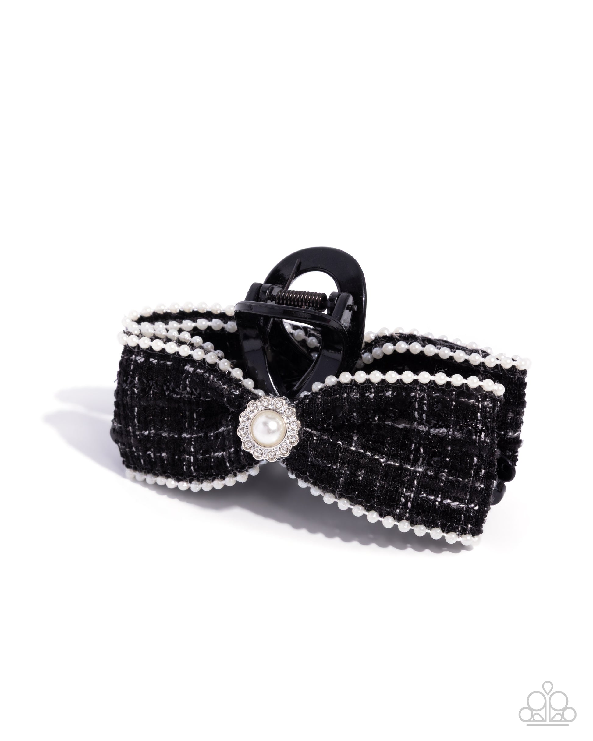 Black bow hair clip with pearl accents on a white background