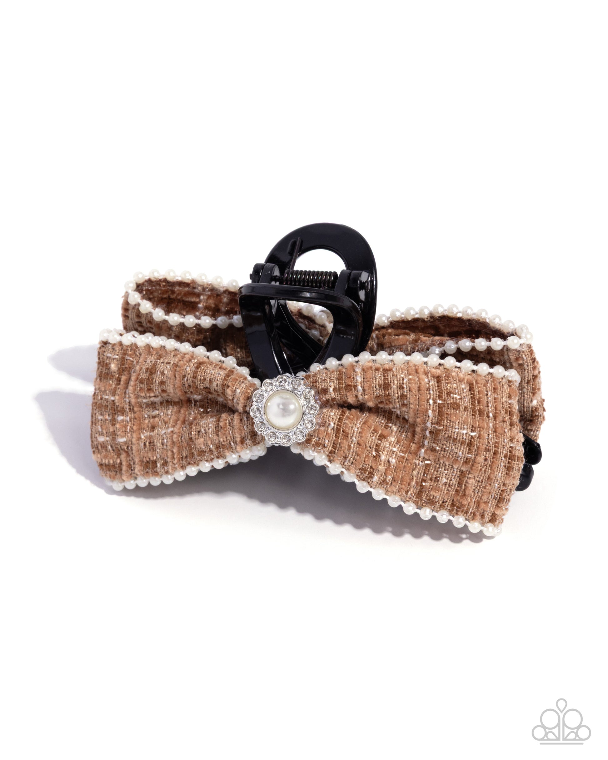 Brown bow tie with pearl center and black clip on a white background