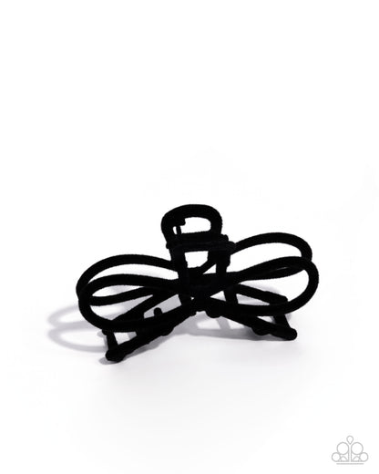 Black hair tie on a white background