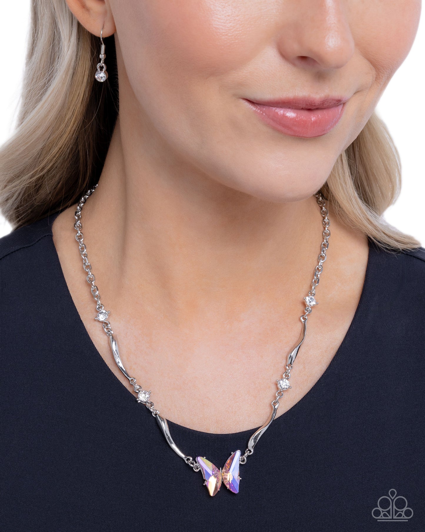 Woman wearing a silver necklace with a purple pendant on a white background