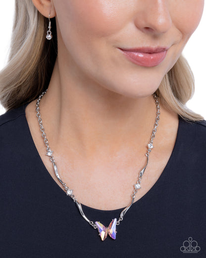 Woman wearing a silver necklace with a purple pendant on a white background