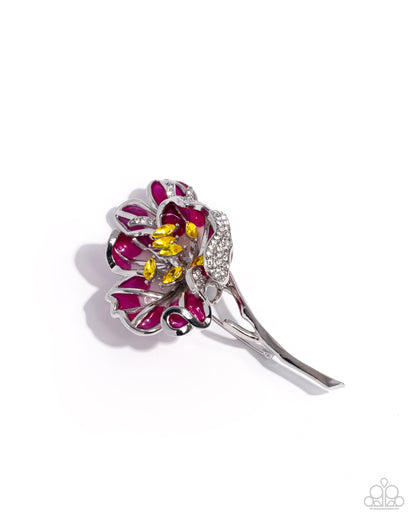 Silver hair clip with red and yellow gemstones on a white background