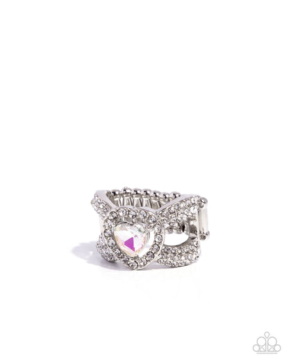 Silver ring with a heart-shaped gem on a white background