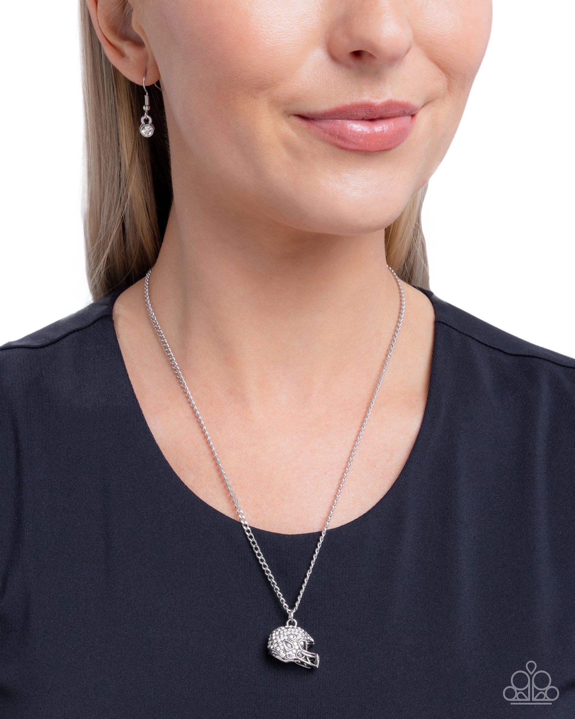 Woman wearing a silver necklace with a pendant on a white background