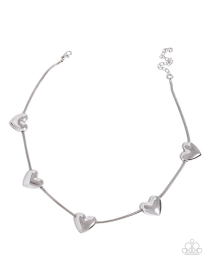 A silver chain necklace featuring five polished heart-shaped charms spaced along the chain, displayed on a clean white background.