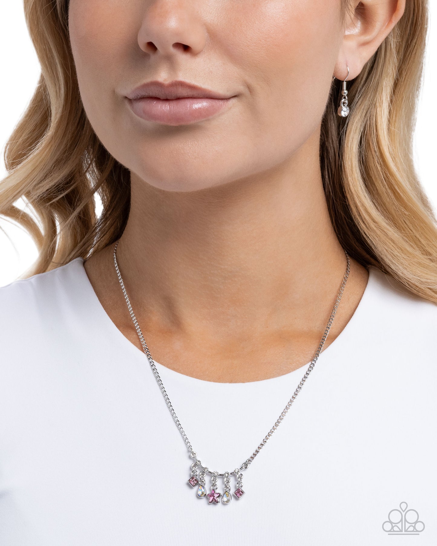 Necklace with pink and clear gemstones worn by a model on a white background