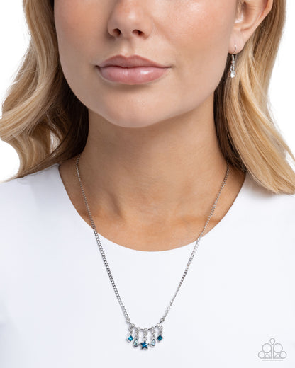 Necklace with blue accents worn by a model on a white background