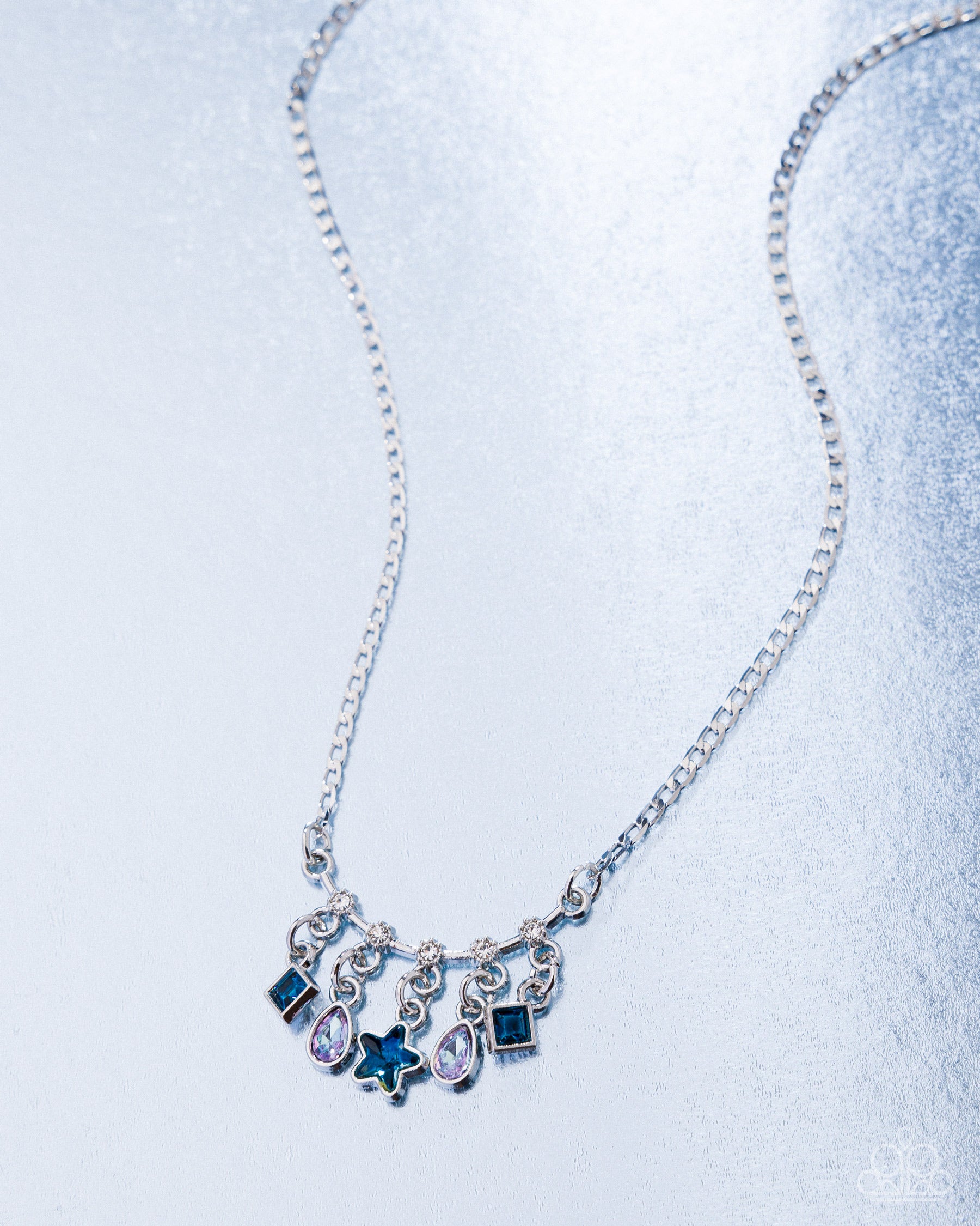 Necklace with star-shaped pendant on a light blue background