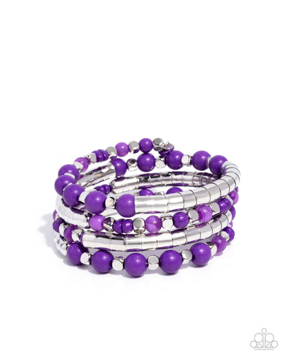Set of purple beaded bracelets on a white background