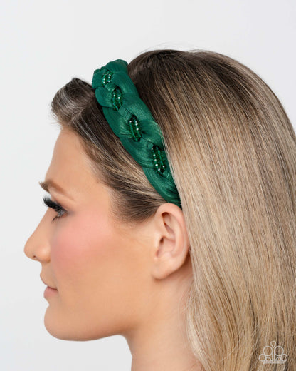 Woman wearing a green headband with decorative elements on a white background