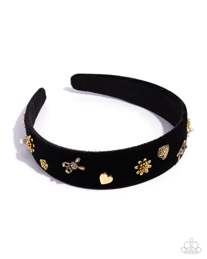 Black headband with gold decorative elements on a white background