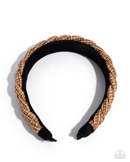 Woven headband with black center on a white background
