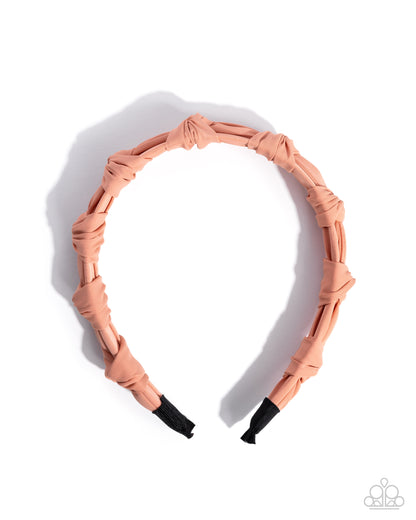 Rose gold headband on a white background