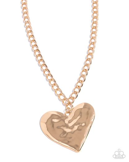 Rose gold heart-shaped pendant on a chain against a white background
