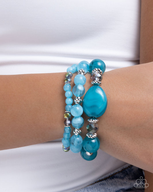 Turquoise beaded bracelet on a wrist with a white background