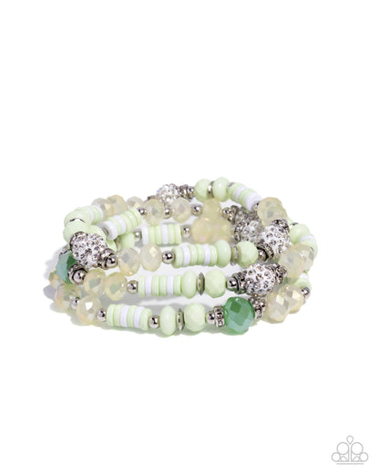 Stack of light green beaded bracelets on a white background