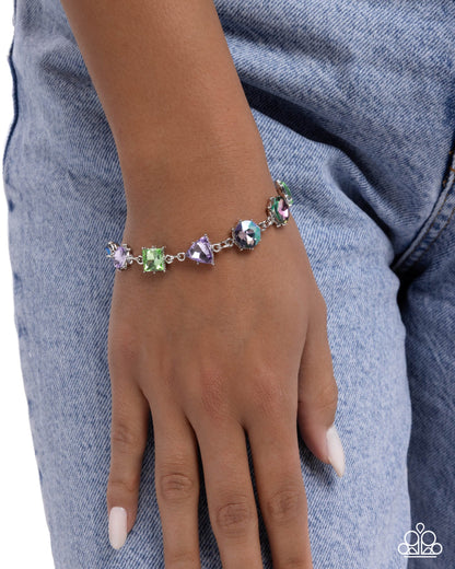 Bracelet with colorful gemstones on a wrist against a denim background