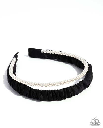 Black headband with white pearls on a white background