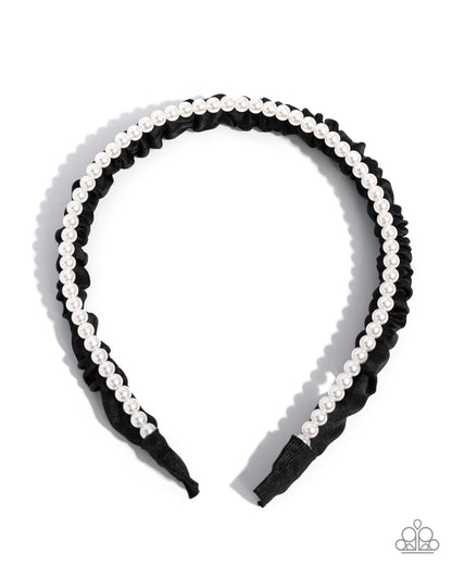 Black headband with white pearls on a white background