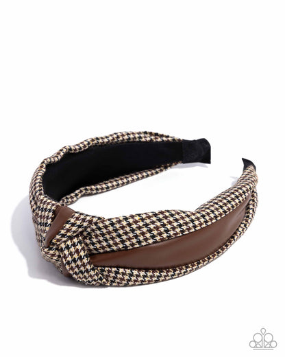 Houndstooth patterned headband with brown accent on a white background