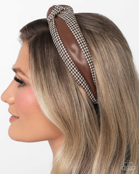 Woman wearing a houndstooth patterned headband on a white background