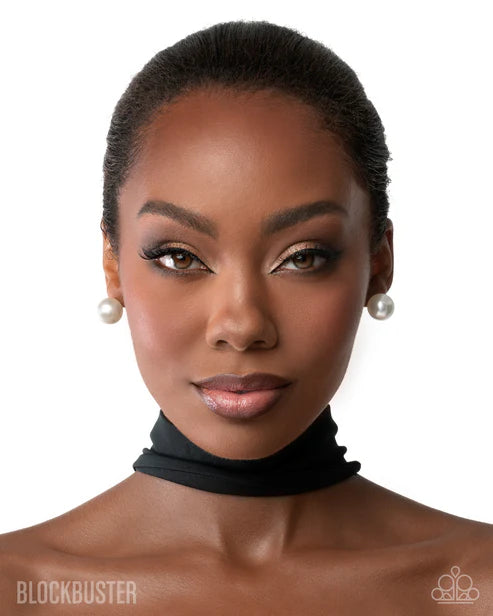 Woman wearing a black choker with a white background