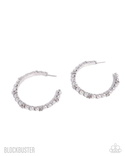 Silver hoop earrings with small stones on a white background