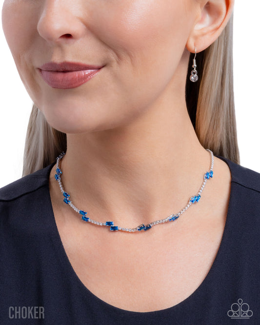 Woman wearing a blue beaded necklace and earrings on a white background