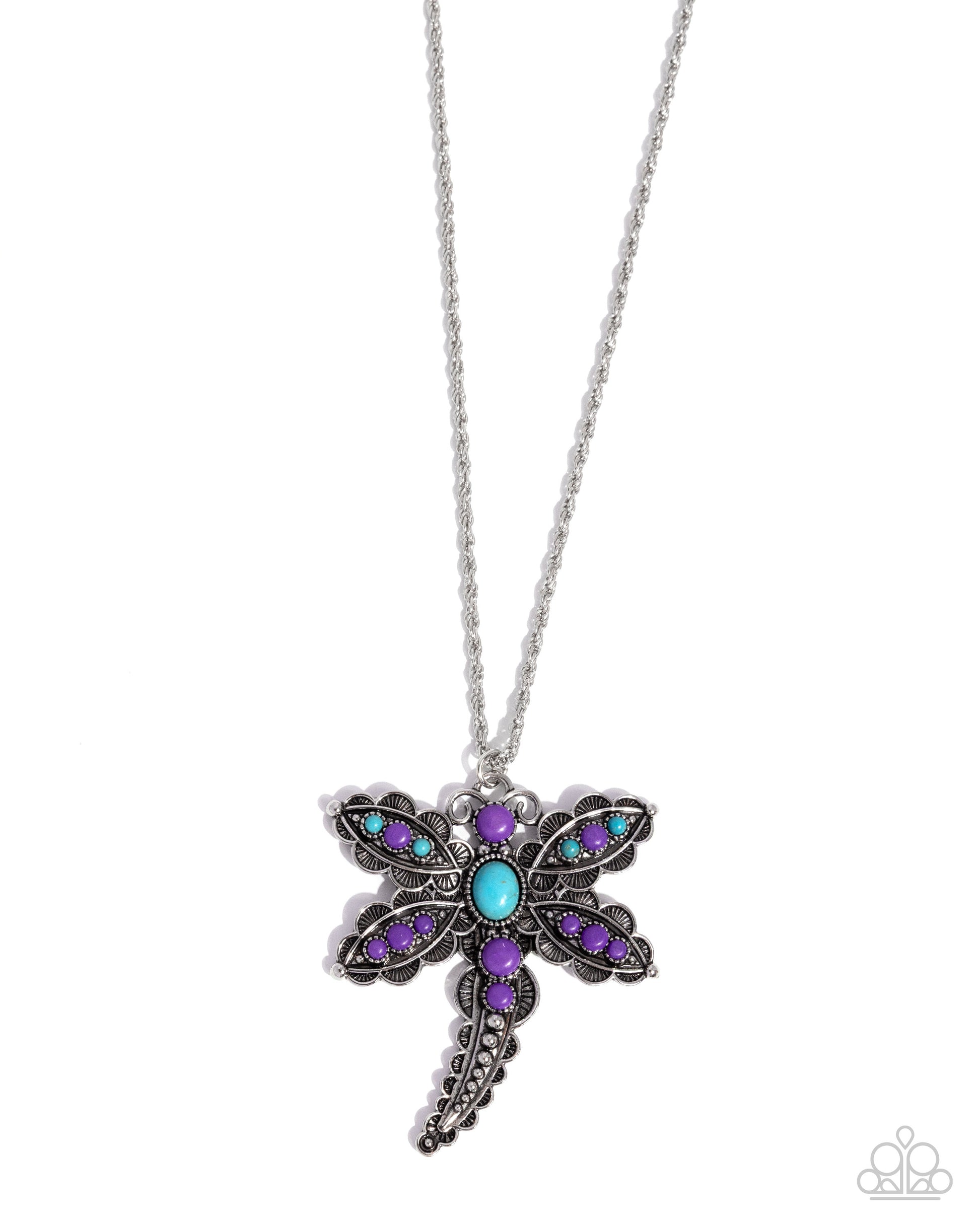 Dragonfly-shaped necklace with purple and blue gemstones on a white background