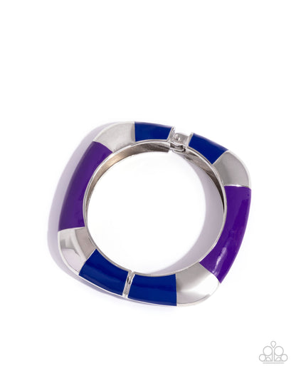 Silver ring with purple and blue concentric bands on a white background