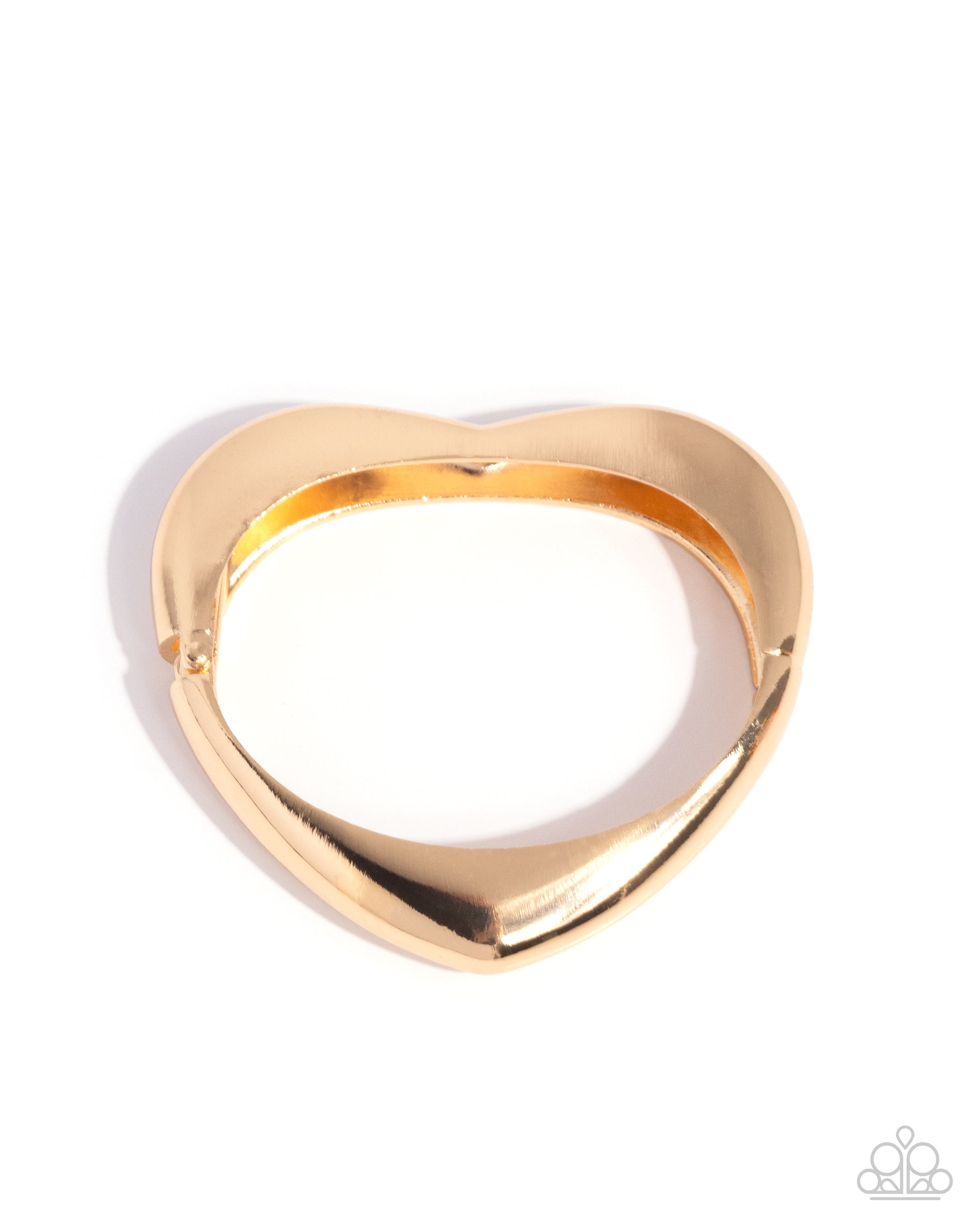 Gold heart-shaped ring on a white background