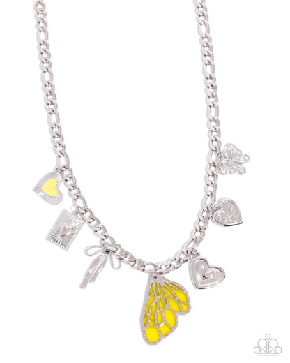Silver necklace with various charms including a yellow butterfly pendant on a white background