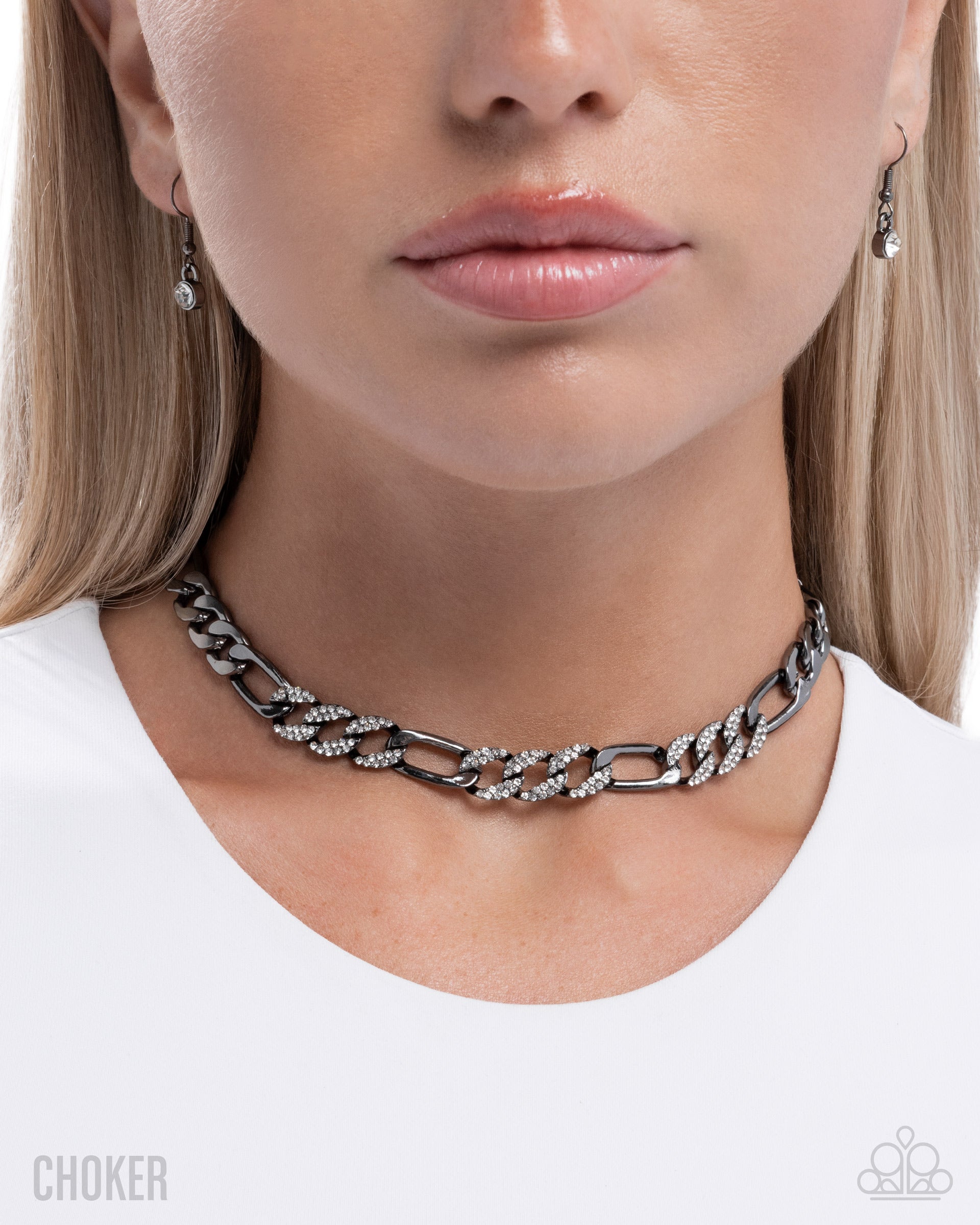 Close-up of a person wearing a silver chain choker necklace on a white background