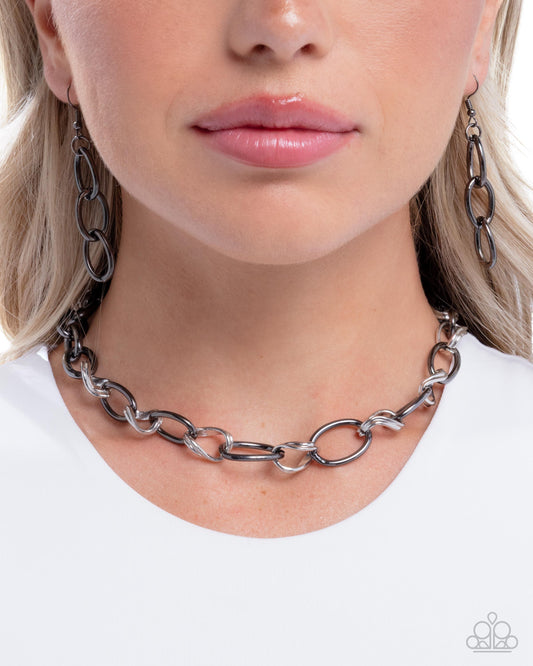 Person wearing a chain necklace with a white background