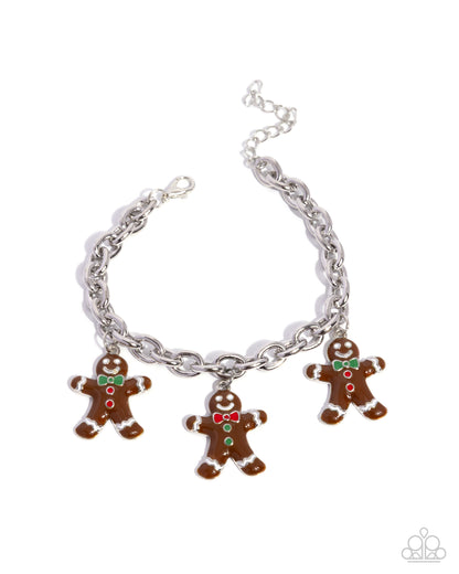 Silver bracelet with gingerbread man charms on a white background