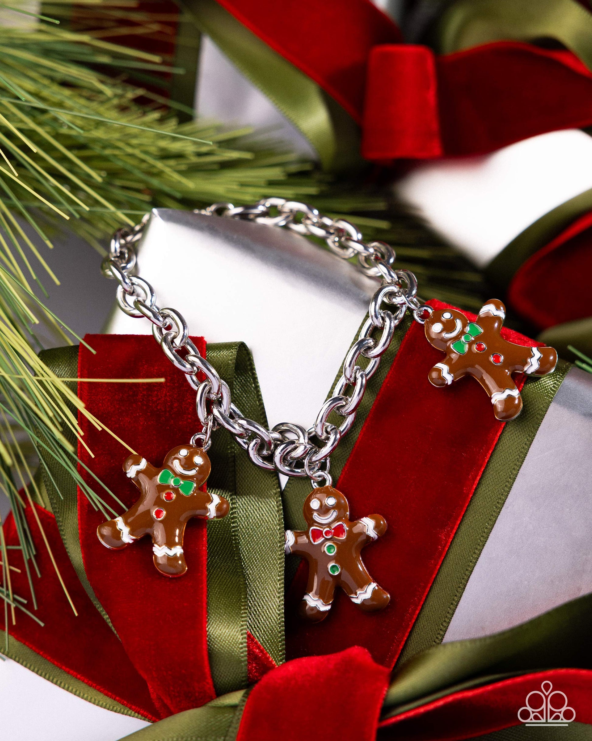 Silver bracelet with gingerbread charm on a red and green gift box