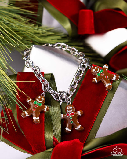 Silver bracelet with gingerbread charm on a red and green gift box