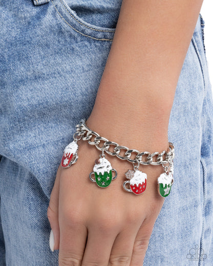 Bracelet with colorful charms on a hand wearing denim jeans