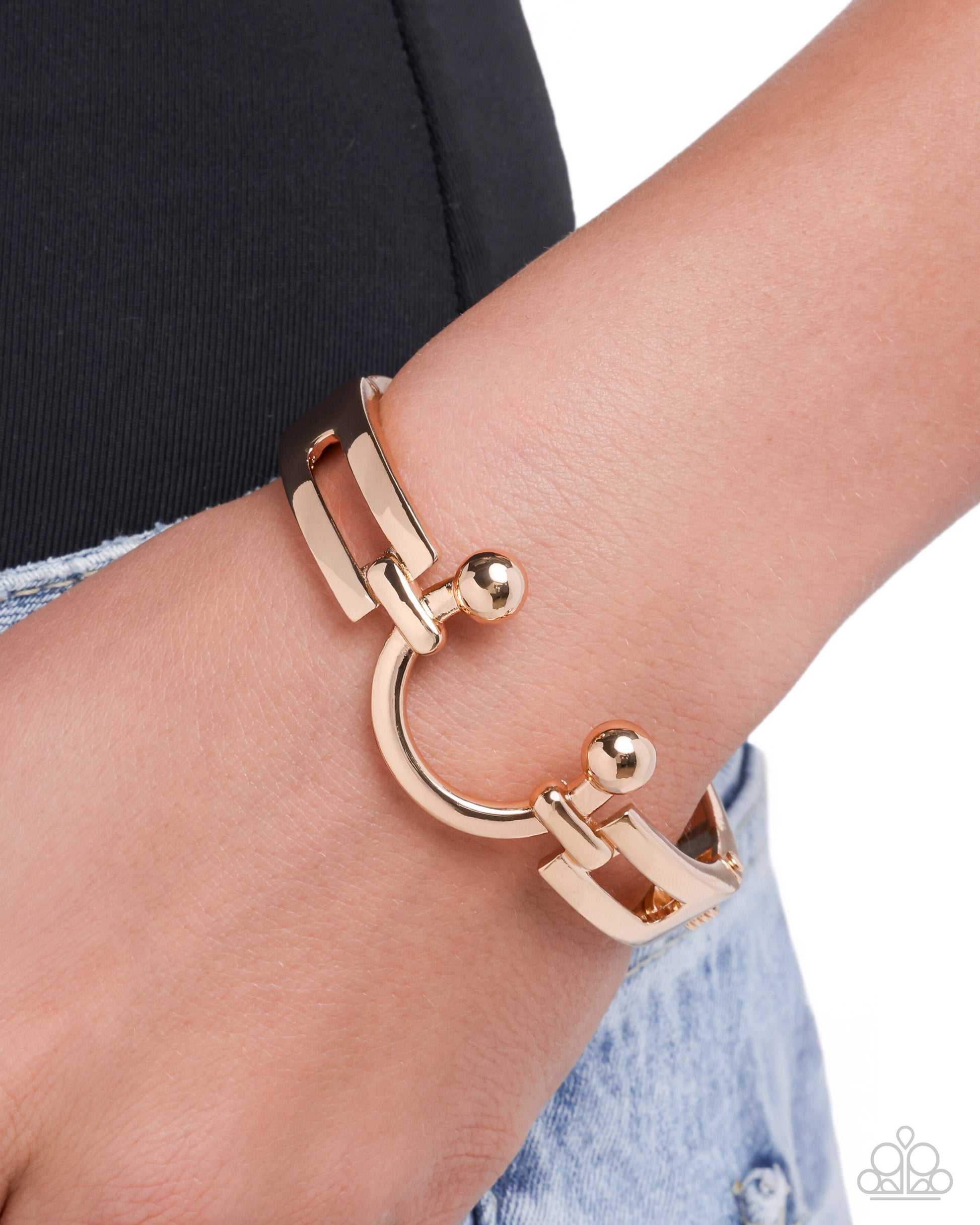 Rose gold bracelet on a wrist with a blurred background