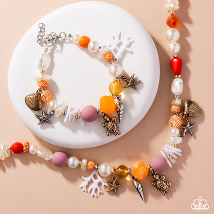 Colorful beaded necklace with shell and starfish charms on a beige background