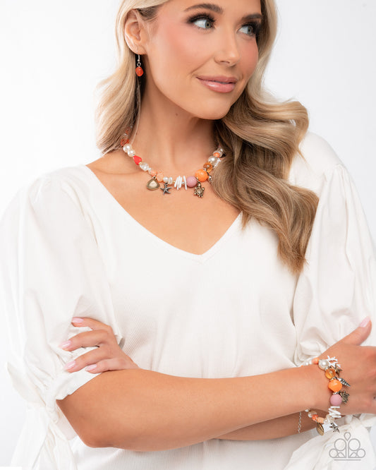 Woman wearing a colorful necklace and bracelet with a white top on a light background