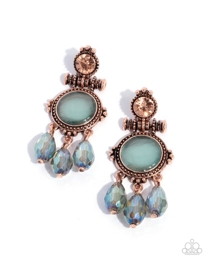 Pair of ornate earrings with rose gold accents and light blue gemstones on a white background
